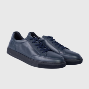 Pair of navy blue leather sneakers with black soles on a white background.